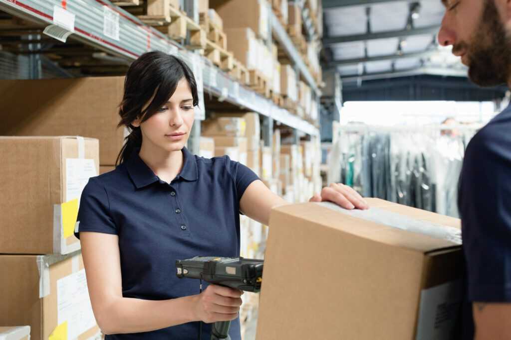 warehouse worker using barcode scanner while receiving product