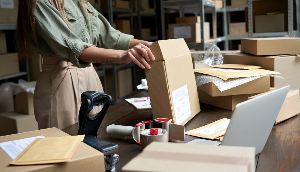 business owner packing eCommerce order with kitting