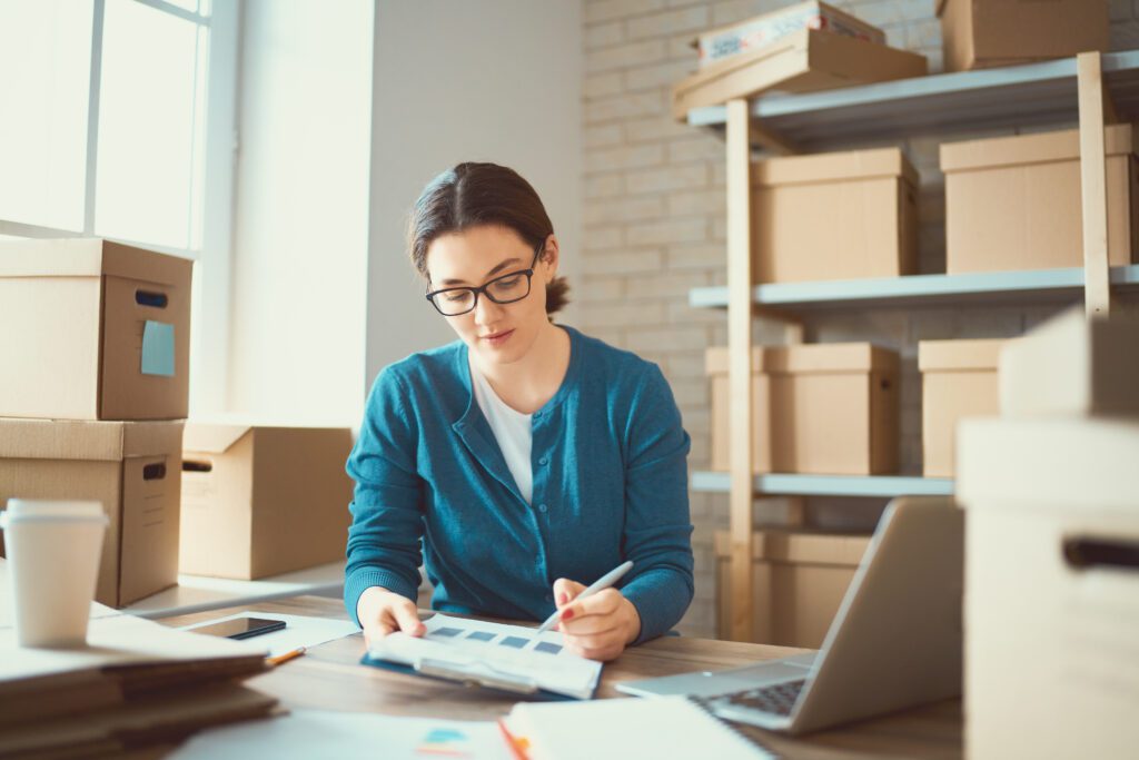 woman working to reduce shipping costs with warehouse management system